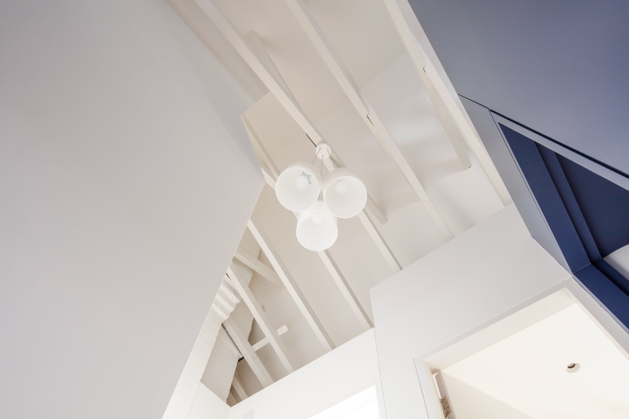 Loft conversion with exposed rafters and modern lighting